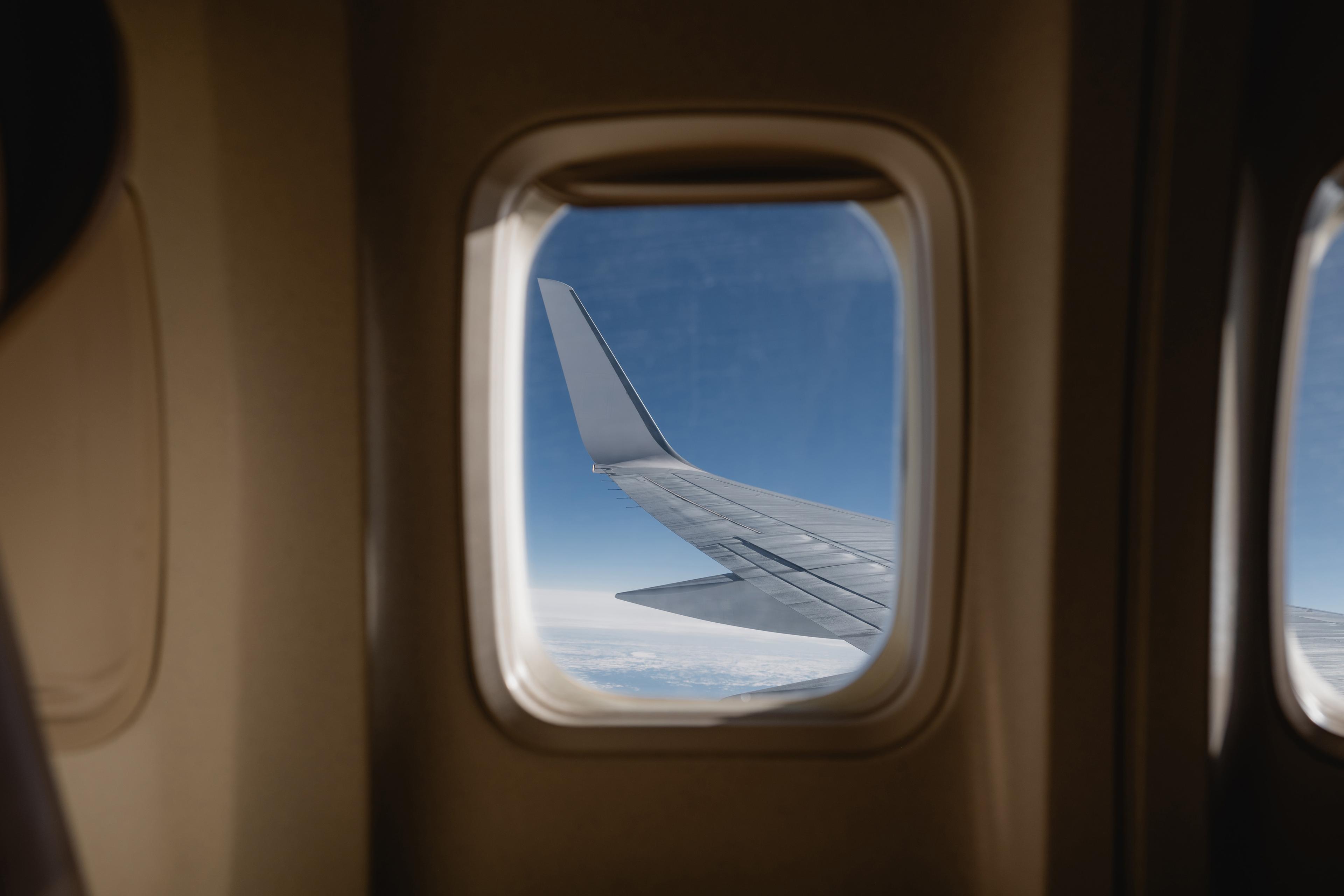 a plane window looking out on the wing